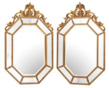 A pair of contemporary gilt wood octagonal marginal mirrors:,