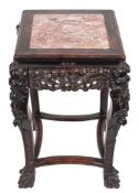 A Chinese carved hardwood square urn table:, the top inset with a panel of rouge variegated marble,