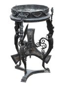A cast iron Athénienne:, the circular bowl decorated with foliate garlands,