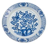 A Chinese blue and white peony and chrysanthemum charger: painted with flowering branches issuing