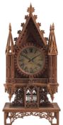 A Gothic mantel clock constructed from cigar boxes: the silvered dial with black Roman numerals,