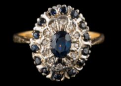 An 18 carat gold, sapphire and diamond oval cluster ring: ring size P 1/2.
