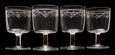 A set of four Cork-style glass rummers and six smaller matching wine glasses: the rounded