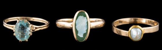 An oval aquamarine single-stone ring:, a half-pearl ring and a hard-stone cameo ring.