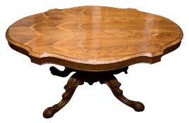A Victorian rosewood oval-shaped breakfast table:,