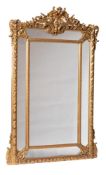 A late 19th/early 20th Century carved giltwood marginal overmantel mirror:, with palmette, C-scroll,