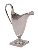 A George III silver cream jug, maker's mark worn, London, 1794: of helmet-shaped outline,
