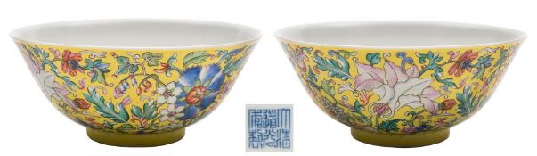 A fine Chinese yellow-ground famille rose bowl: the exterior enamelled with numerous blooms
