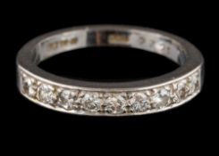An 18 carat white gold and diamond half hoop ring: pave-set with round brilliant-cut diamonds,
