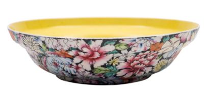 A Chinese millefleur yellow ground famille noire shallow bowl: of ogee form,