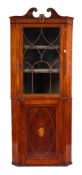 An early 19th Century mahogany and inlaid standing corner cupboard:, bordered with boxwood lines,