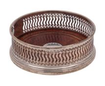 An Elizabeth II silver bottle coaster, maker W I Braodway & Co, Birmingham, 1997: of circular form,