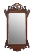 A walnut and parcel gilt fret carved mirror in the Georgian taste:, with Ho-Ho bird cresting,