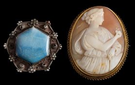 An oval shell cameo mounted brooch: with classical female figure of 'Eve' presenting the apple