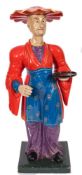 A carved wood and painted dumb waiter in the form of a standing Chinese figure:,