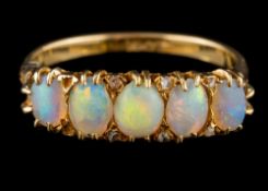 An 18 carat gold and opal five-stone ring: set with graduated oval opals between rose-diamond