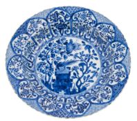 A Chinese blue and white deep dish: painted with a pheasant perched on angular rockwork with lotus