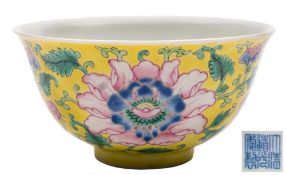 A Chinese yellow-ground famille rose 'peony' bowl: finely enamelled with three peony flowers