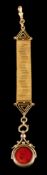 A 9 carat gold swivel fob: the two sided fob set with a circular panel on carnelian and bloodstone,