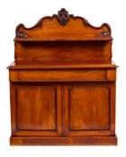 A Victorian mahogany chiffonier:, the shelved superstructure with a shaped ledge back,