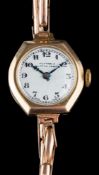 A lady's 9ct gold cased wristwatch, the dial signed 'Huxtables Newton Abbot':and case.
