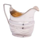 A George III silver cream jug, maker's mark worn, London, 1803: of barge-shaped outline,
