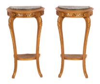 A pair of French carved giltwood demi lune console tables:, each with a green variegated marble top,