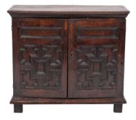 An oak dwarf side cupboard in the Jacobean taste:, with a moulded top,