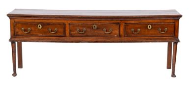 An 18th Century oak dresser base:, with a moulded top, containing three short crossbanded drawers,