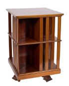 An Edwardian mahogany and inlaid square revolving bookcase:, bordered with boxwood,