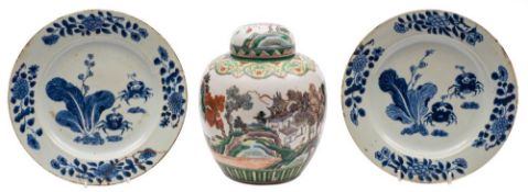 A Chinese famille verte jar and cover and a pair of blue and white plates: the first painted with