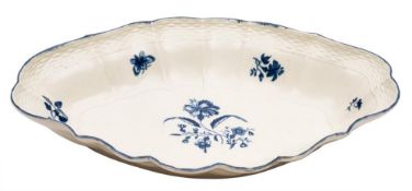 A First Period Worcester blue and white oval dish: the scallop shaped rim with basket weave border,