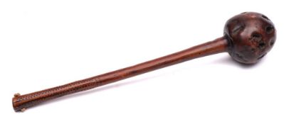 A South African hardwood knobkerrie: the rounded bulbous head on tapering shaft with geometric chip