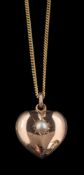 A late Victorian 9 carat gold heart pendant, the heart set with a half pearl in a star setting,
