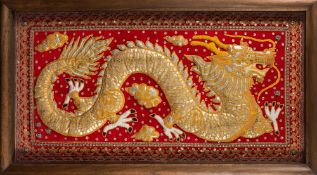A large Burmese raised wirework and embroidered panel: of a dragon amongst clouds,