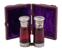 A Victorian silver and ruby glass double ended scent bottle, unmarked: of cylindrical outline,