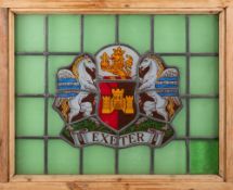 A stained glass panel bearing the Exeter City Coat-of-Arms: to a green ground and contained in a