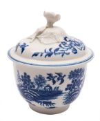 A First Period Worcester blue and white sucrier and cover and a cream jug: the first with flower