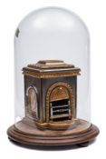A steel and gilt metal miniature model of a fireplace: of rectangular outline,