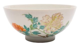 A Chinese famille rose bowl: the exterior enamelled with peony sprays and pierced blue rockwork,