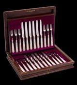 A set of twelve George V silver fruit knives and twelve forks, maker William Hutton & Sons Ltd,