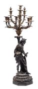 A large Victorian bronzed spelter figural ten light candelabrum: the ten foliate branches with