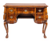 A South African stinkwood block front kneehole dressing table:, the moulded top with canted angles,