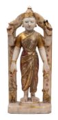 An Indian alabaster and polychrome decorated temple figure: the four armed figure standing beneath