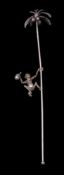 A Continental silver novelty swizzle stick: modelled as a monkey climbing a palm tree to collect