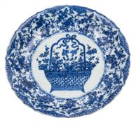 A Chinese blue and white 'basket of flowers' dish: painted with a central medallion of a large