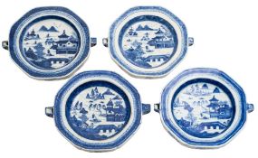 A group of four Chinese blue and white warming dishes: each painted with a pagoda lake landscape