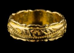 A gold coloured ring: the band with a foliate motif, stamped 14K, ring size M, 4.1g.