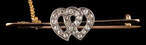 A diamond mounted bar brooch: with central double heart motif,