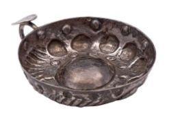 A Continental silver wine taster: of traditional circular design with domed centre with loop handle